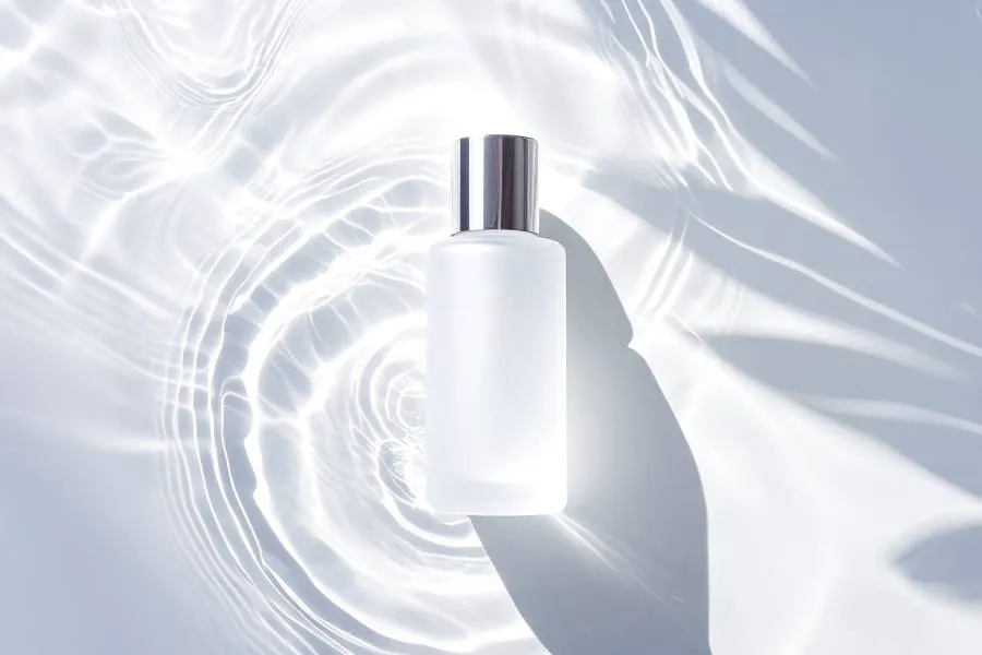 toner laying in water and white background